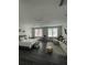 Spacious bedroom featuring a seating area, dark wood floors and multiple windows providing plenty of natural light at 8919 Lakeshore Pointe Dr, Winter Garden, FL 34787