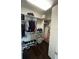 Walk-in closet offers ample storage space with dark hardwood floors at 8919 Lakeshore Pointe Dr, Winter Garden, FL 34787