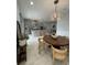 Open dining area adjacent to the kitchen featuring modern lighting and comfortable seating, perfect for gatherings at 8919 Lakeshore Pointe Dr, Winter Garden, FL 34787