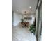 Bright dining room features a round table, modern light fixture, white wainscoting, and neutral tile flooring at 8919 Lakeshore Pointe Dr, Winter Garden, FL 34787