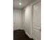 Hallway featuring dark wood floors and crisp white doors and trim at 8919 Lakeshore Pointe Dr, Winter Garden, FL 34787