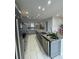 Modern kitchen features stainless steel appliances, granite countertops, and ample cabinet space for storage at 8919 Lakeshore Pointe Dr, Winter Garden, FL 34787