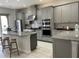 Modern kitchen with stainless appliances, granite countertops, and ample cabinetry for storage at 8919 Lakeshore Pointe Dr, Winter Garden, FL 34787