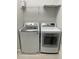Laundry room with modern washer and dryer and wire shelving at 8919 Lakeshore Pointe Dr, Winter Garden, FL 34787