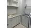 Bright laundry room featuring sink, cabinets, and a modern washer and dryer at 8919 Lakeshore Pointe Dr, Winter Garden, FL 34787