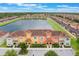 Scenic aerial view of townhomes overlooking a lake and lush landscaping at 8942 Cuban Palm Rd, Kissimmee, FL 34747