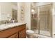 Well-lit bathroom featuring a granite countertop vanity and glass-enclosed shower at 8942 Cuban Palm Rd, Kissimmee, FL 34747