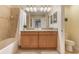 Bright bathroom with double vanity, granite counters, and a shower/tub combo at 8942 Cuban Palm Rd, Kissimmee, FL 34747