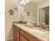 Bathroom featuring double sink vanity with a granite countertop and nautical decorative elements at 8942 Cuban Palm Rd, Kissimmee, FL 34747
