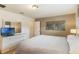 Neutrally-toned bedroom with TV, mirror and ample space at 8942 Cuban Palm Rd, Kissimmee, FL 34747