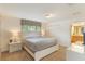 Bright, neutrally decorated bedroom with carpet flooring and a bathroom visible in the background at 8942 Cuban Palm Rd, Kissimmee, FL 34747