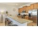 Stylish kitchen with granite countertops, stainless steel appliances, and a breakfast bar at 8942 Cuban Palm Rd, Kissimmee, FL 34747