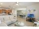 Comfortable living room with a view into a modern kitchen and a bright dining area at 8942 Cuban Palm Rd, Kissimmee, FL 34747