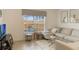 Cozy living room featuring comfortable seating, a large window, and stylish decor at 8942 Cuban Palm Rd, Kissimmee, FL 34747