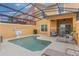 Inviting backyard pool area with screened enclosure, lounge chairs, and outdoor seating at 8942 Cuban Palm Rd, Kissimmee, FL 34747