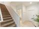 Hallway with stairs, neutral tones, and a view into a partial bathroom at 8942 Cuban Palm Rd, Kissimmee, FL 34747