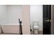 Modern bathroom featuring a freestanding tub, matte black finishes and a separate toilet room at 9345 Atlanta Dr, St Cloud, FL 34773