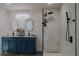 Contemporary bathroom featuring a double sink vanity, sleek black fixtures, and tiled walk-in shower at 9345 Atlanta Dr, St Cloud, FL 34773