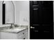 Modern bathroom featuring a vessel sink, sleek vanity with a black door for contrast and a mirror at 9345 Atlanta Dr, St Cloud, FL 34773