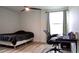 Bedroom featuring wood flooring, a ceiling fan, a window and a workspace with black office chair at 9345 Atlanta Dr, St Cloud, FL 34773