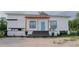 Inviting single-story home with a bright blue front door, pergola, and charming front porch at 9345 Atlanta Dr, St Cloud, FL 34773
