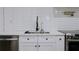 Kitchen with stainless steel appliances, modern faucet, white cabinets, light countertops and tile backsplash at 9345 Atlanta Dr, St Cloud, FL 34773