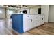 Kitchen island with white cabinets, drawers, blue end panel and a countertop at 9345 Atlanta Dr, St Cloud, FL 34773