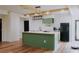 Modern kitchen featuring a central island, stainless steel appliances, and stylish light fixture at 9345 Atlanta Dr, St Cloud, FL 34773