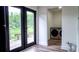 Laundry room featuring modern machines, access to the deck and an exterior view at 9345 Atlanta Dr, St Cloud, FL 34773