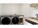 Large laundry room featuring front load modern machines, countertops and storage space at 9345 Atlanta Dr, St Cloud, FL 34773