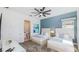Bedroom features two beds, an en suite bathroom and light-colored walls at 1005 Coyote Creek Way, Reunion, FL 34747