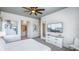 Bright bedroom features a TV, ceiling fan and en suite bathroom at 1005 Coyote Creek Way, Reunion, FL 34747