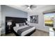 This bedroom features plush carpets, a king bed, a full-length headboard, and abstract artwork at 1005 Coyote Creek Way, Reunion, FL 34747