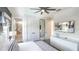 Comfortable bedroom featuring a ceiling fan, carpeted floors, and a bathroom with a glass shower at 1005 Coyote Creek Way, Reunion, FL 34747