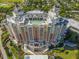 Aerial view of a luxurious resort featuring a rooftop pool, multiple balconies, and impeccable architecture at 1005 Coyote Creek Way, Reunion, FL 34747