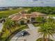 Grand estate with lush landscaping, circular driveway, and golf course views, creating an inviting and luxurious appeal at 1005 Coyote Creek Way, Reunion, FL 34747