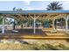Spacious poolside cabana with games, wood floors and white support beams; a perfect outdoor retreat at 1005 Coyote Creek Way, Reunion, FL 34747