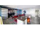 Bright game room features a wet bar, foosball table and adjacent theater room with barn doors at 1005 Coyote Creek Way, Reunion, FL 34747