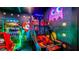 Brightly colored arcade game room offers a variety of entertainment options for endless fun at 1005 Coyote Creek Way, Reunion, FL 34747