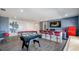 Spacious game room with a bar, pool table, foosball, and entertainment area at 1005 Coyote Creek Way, Reunion, FL 34747