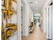 Bright hallway features neutral tile floors and decorative artwork adorning the walls at 1005 Coyote Creek Way, Reunion, FL 34747