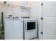 Convenient laundry room featuring modern, white washer and dryer for easy laundry care at 1005 Coyote Creek Way, Reunion, FL 34747