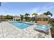 Outdoor pool area features a Tiki bar, a basketball hoop and plenty of lounge seating at 1005 Coyote Creek Way, Reunion, FL 34747