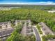 Aerial view of the community surrounded by trees and a pond at 10746 Regent Square Dr # 1502, Orlando, FL 32825