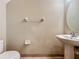 Bathroom features a pedestal sink, toilet and towel rack with neutral walls and tile flooring at 10746 Regent Square Dr # 1502, Orlando, FL 32825