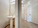 Powder room featuring a pedestal sink and a decorative oval mirror with tiled flooring and neutral wall color at 10746 Regent Square Dr # 1502, Orlando, FL 32825