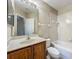 Cozy bathroom features a single sink vanity, tiled tub, and toilet at 10746 Regent Square Dr # 1502, Orlando, FL 32825