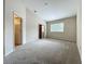 Spacious bedroom featuring neutral carpet, a window, and access to a walk-in closet at 10746 Regent Square Dr # 1502, Orlando, FL 32825