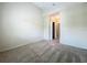 A carpeted bedroom with a closet, with neutral colored walls and trim throughout, and a double electric outlet at 10746 Regent Square Dr # 1502, Orlando, FL 32825