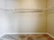 Empty walk-in closet with wire shelving and neutral colored carpet at 10746 Regent Square Dr # 1502, Orlando, FL 32825